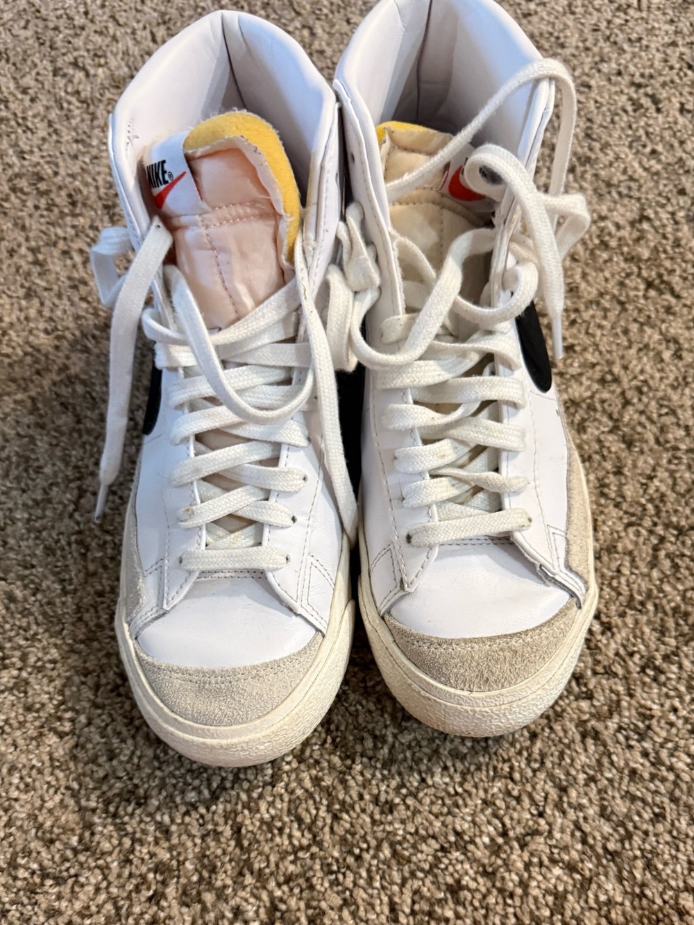 Nike White High-Top Sneakers with Black Swoosh and Yellow Tongue Accent